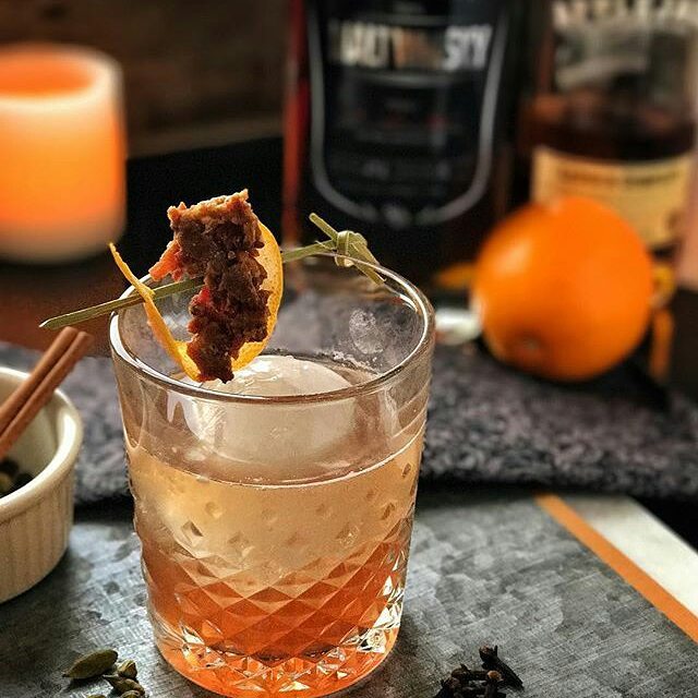 a cocktail in a highball glass