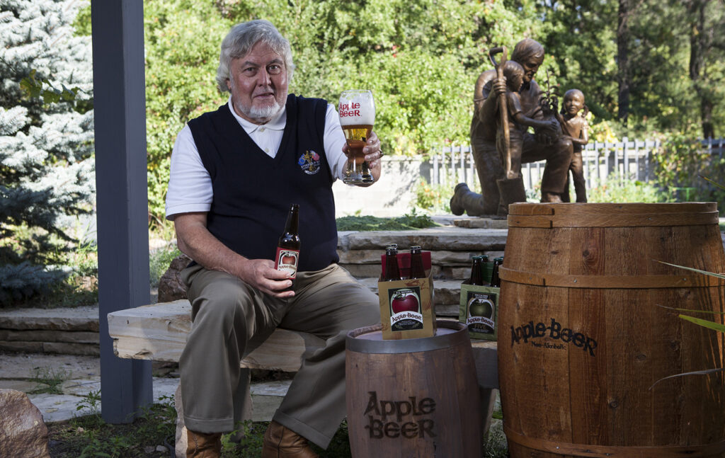 Apple Beer man offering a class of the Product