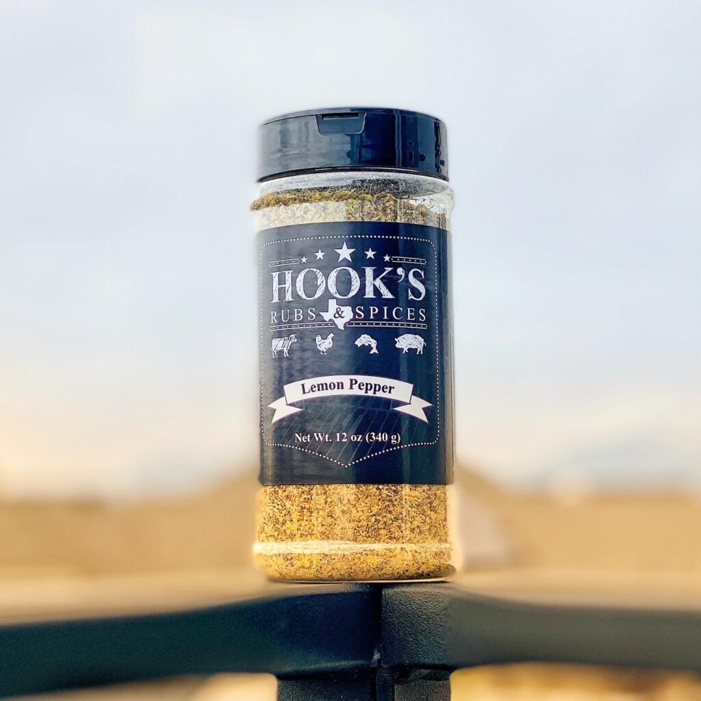 A jar of spices balancing on a wooden fence