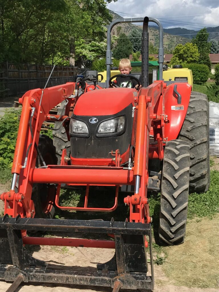 A red tractor parked in front of a house