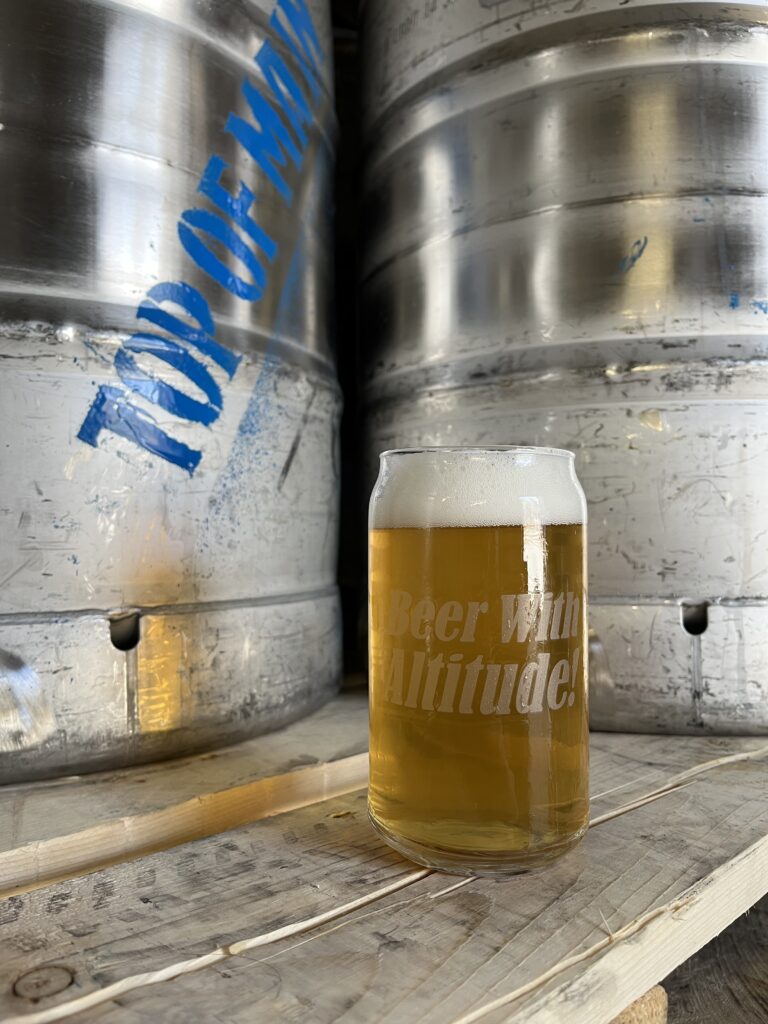 a glass of beer on a wooden table
