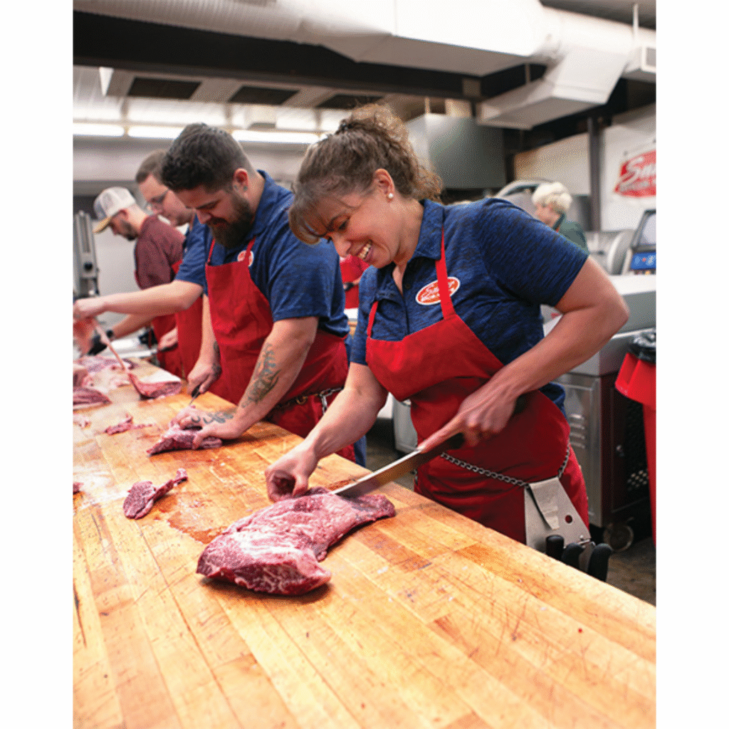 Snider Bros Meats Employees cutting meat