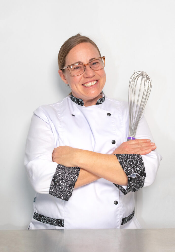 A chef holding a whisk