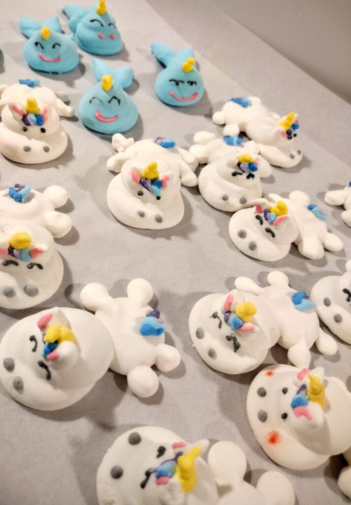 A table covered with a variety of white and blue buttons