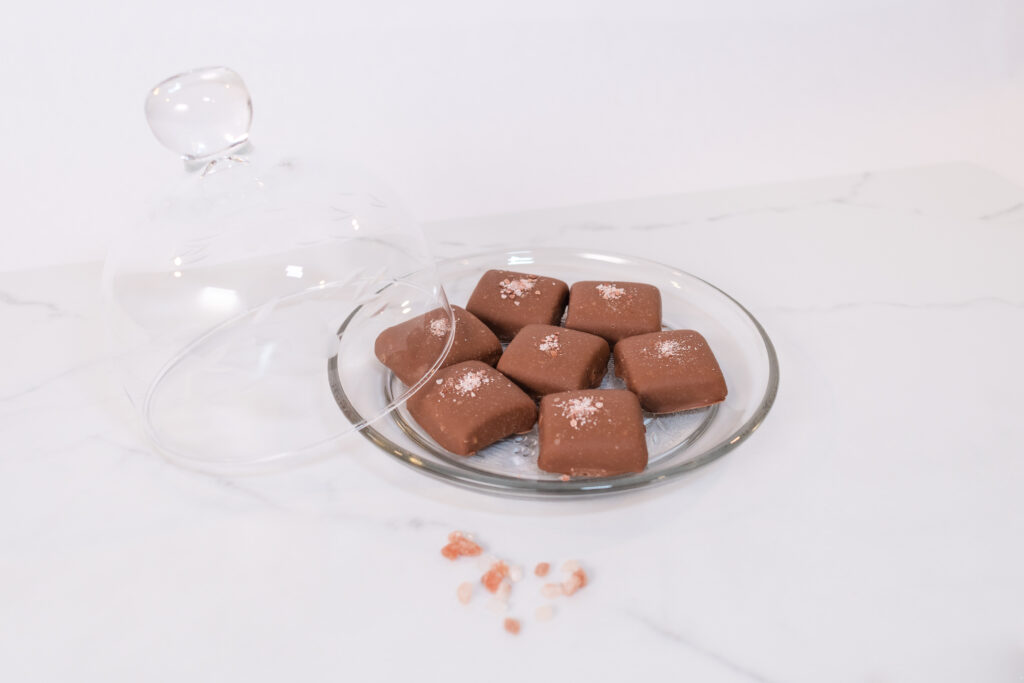A plate of assorted chocolates on a marble table