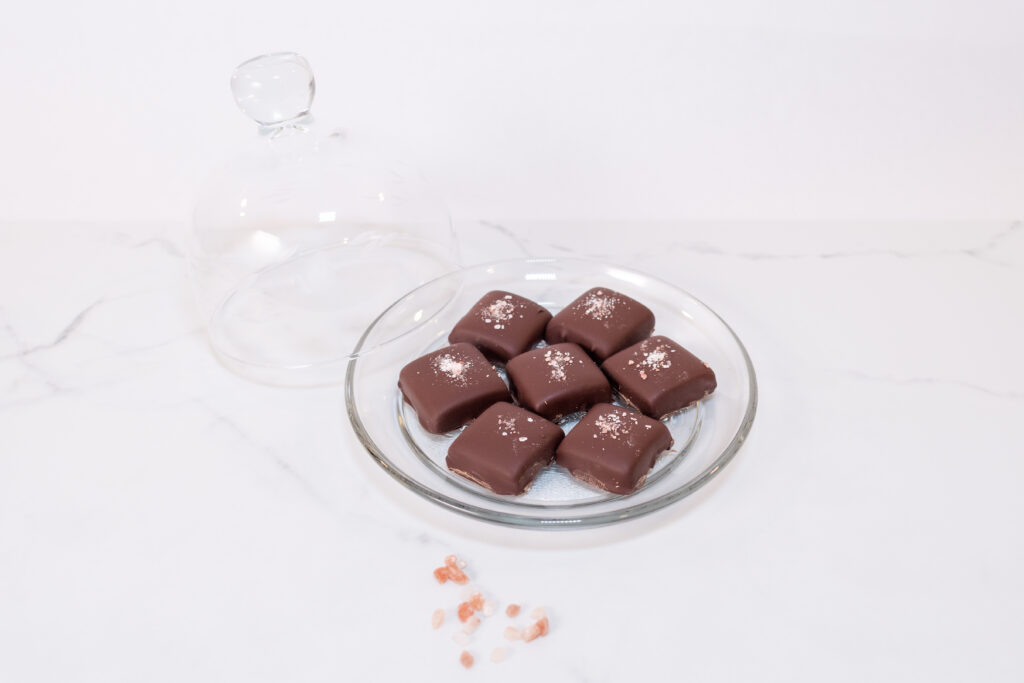 A plate of assorted chocolates on a white table