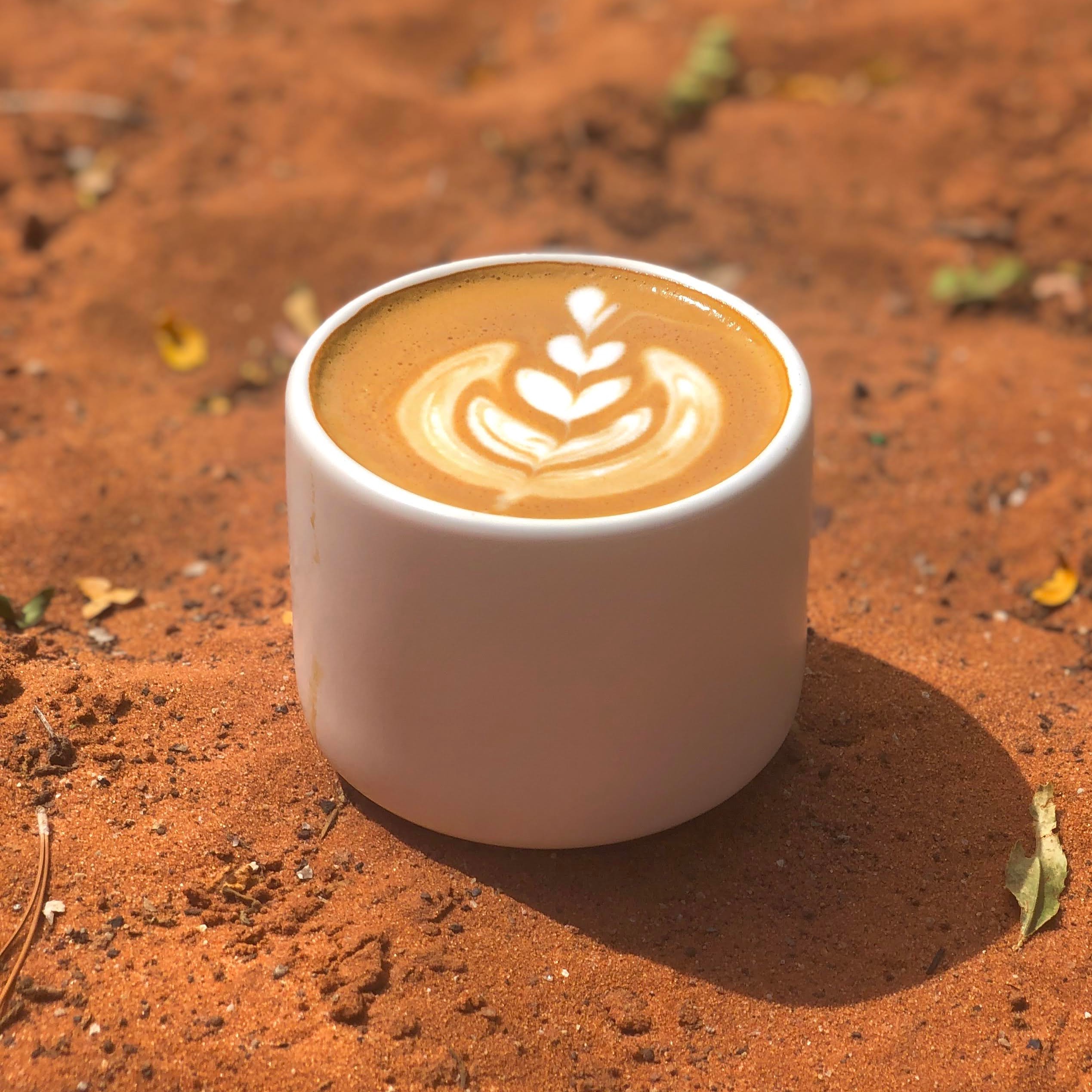 A cappuccino with a heart-shaped latte art design on top