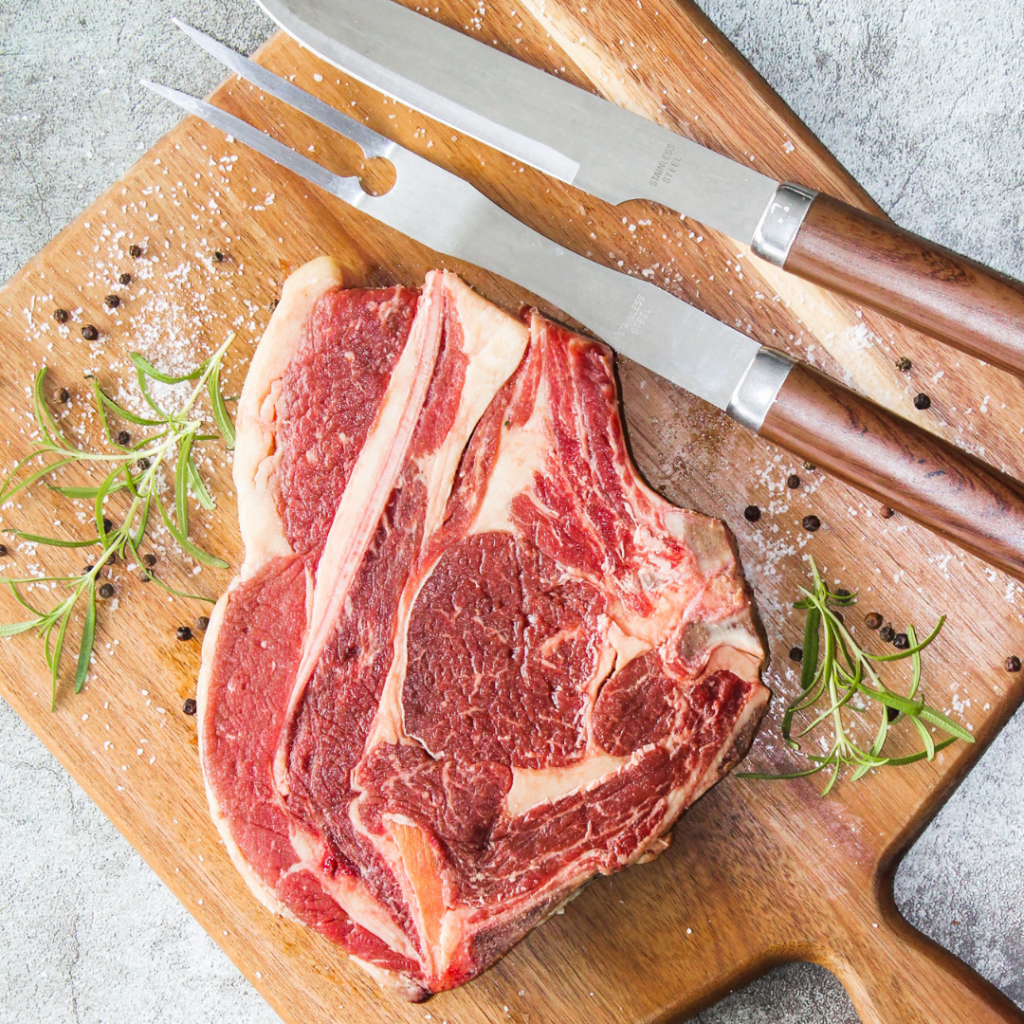 Cut of steak on cutting board with seasoning