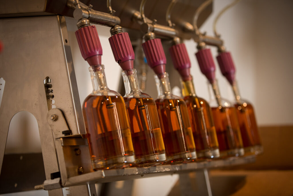 several bottles of liquid are lined up in a row