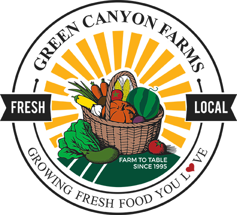 A basket of fresh vegetables featuring the Green Canyon Farmers logo