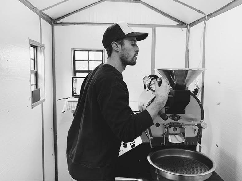 A man in a kitchen preparing food for a cooking show