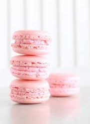 A stack of pink macaroons on a table