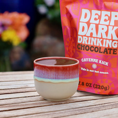 Drinking chocolate in cup with churro